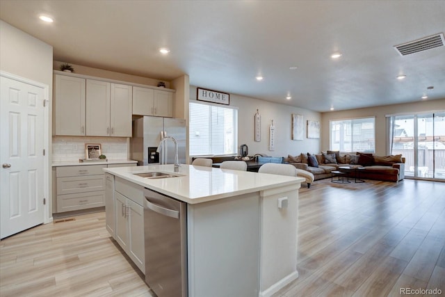 2785 Black Hawk Pl, Brighton, CO 80601 - kitchen featuring stainless steel appliances, a sink, light wood finished floors, light countertops, and recessed lighting