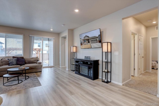 2785 Black Hawk Pl, Brighton, CO 80601 - living area with wood finished floors, baseboards, recessed lighting, and a fireplace
