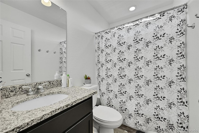 bathroom with toilet, a shower with curtain, and vanity