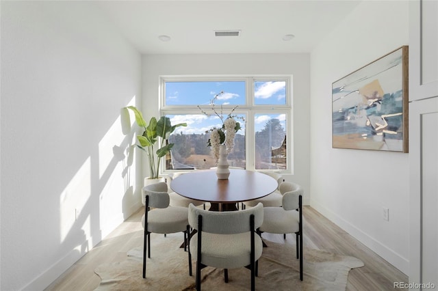 dining space featuring light wood-type flooring