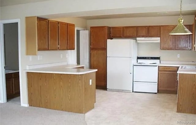 kitchen featuring white appliances, pendant lighting, and sink