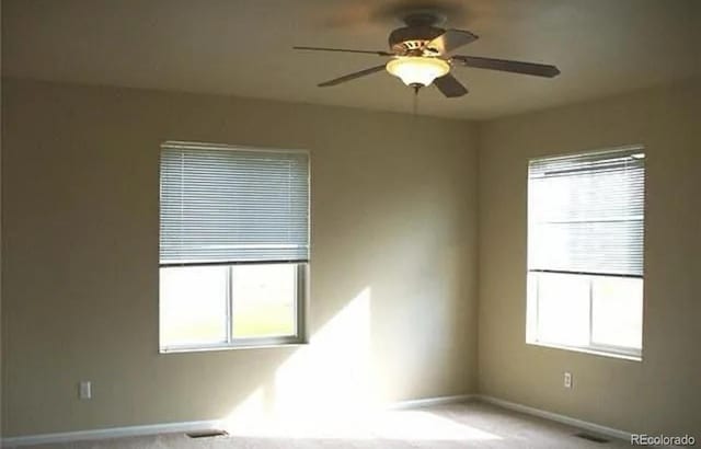 unfurnished room with carpet floors and ceiling fan