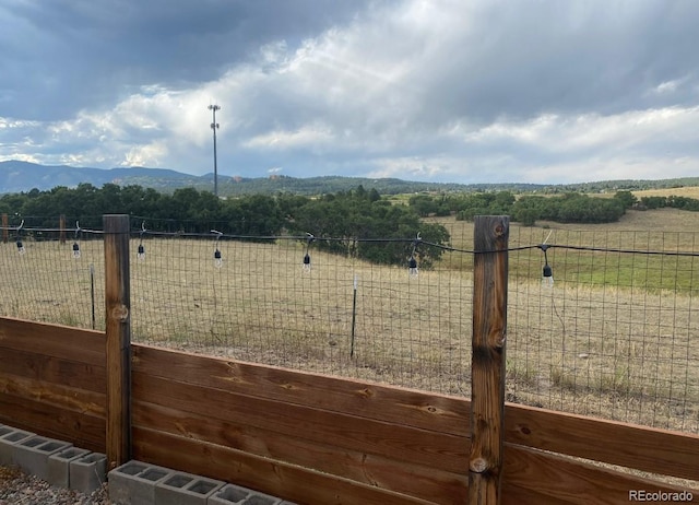 view of yard with a rural view and a mountain view