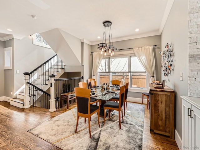 dining area with baseboards, wood finished floors, stairs, and crown molding