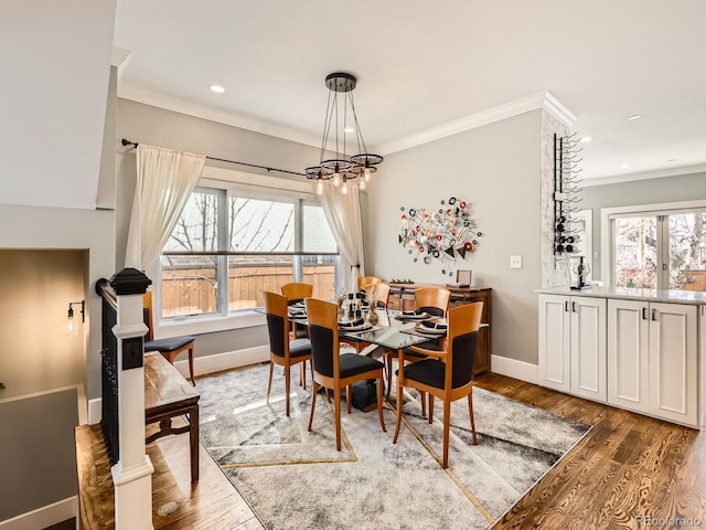 dining space featuring crown molding and wood finished floors