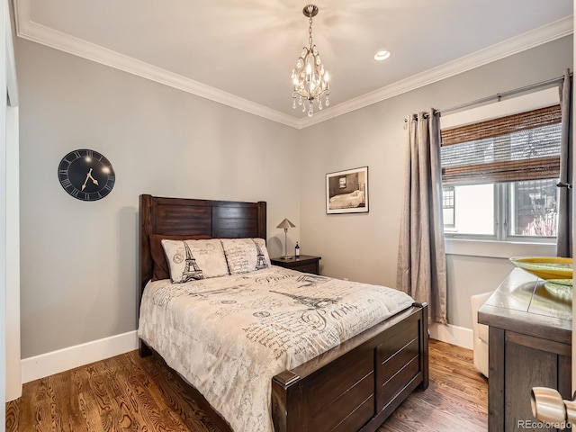 bedroom with a chandelier, ornamental molding, wood finished floors, and baseboards