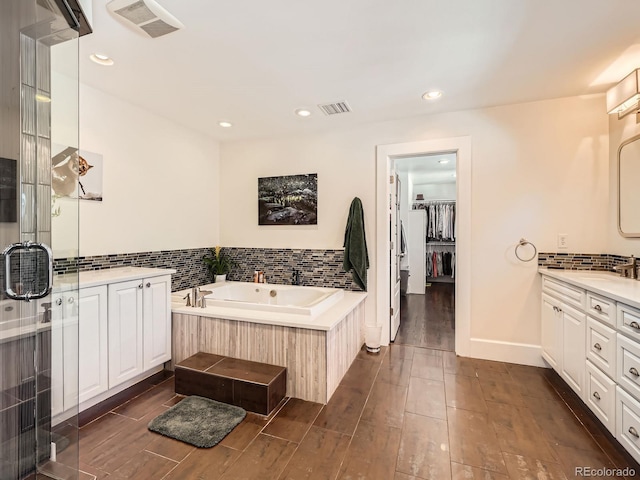 full bath with wood finish floors, vanity, and visible vents