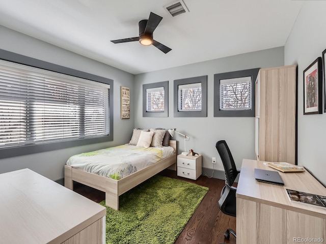 bedroom with dark wood-style floors and visible vents