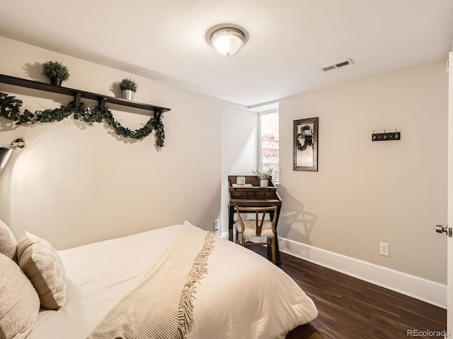 bedroom with dark wood-type flooring, visible vents, and baseboards