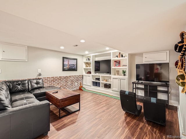 living area featuring built in features, visible vents, wood finished floors, and recessed lighting