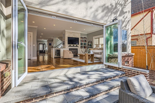 view of patio with beverage cooler and fence