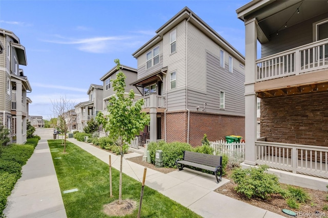 view of home's community with a residential view and a lawn