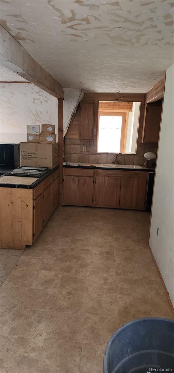 1 Ute Trl, Evergreen, CO 80439 - kitchen with brown cabinetry and a sink
