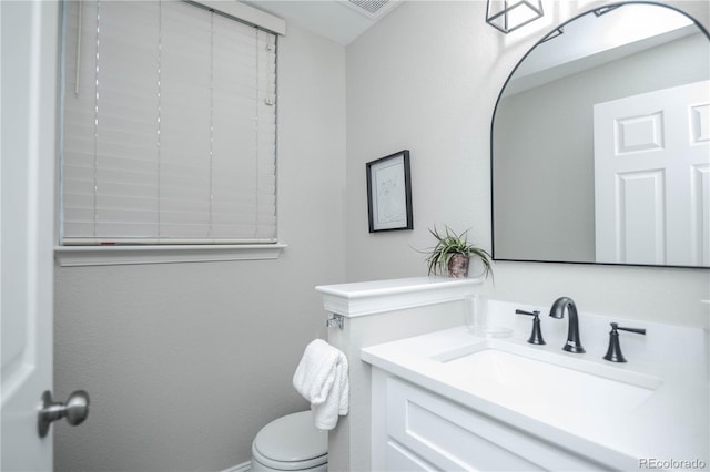 bathroom featuring vanity and toilet