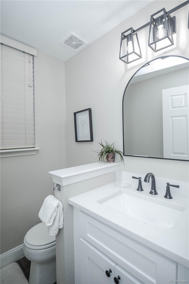 bathroom featuring vanity and toilet