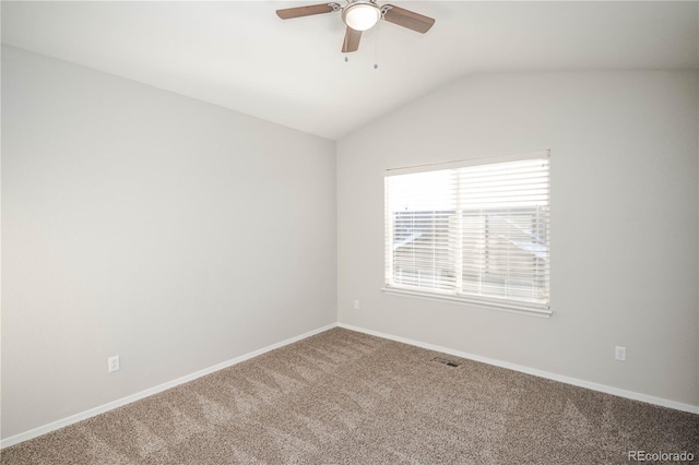 carpeted empty room featuring ceiling fan and vaulted ceiling