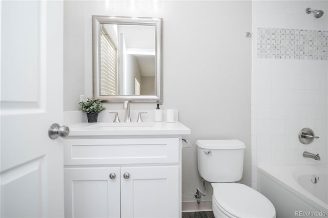 full bathroom featuring vanity, toilet, and tiled shower / bath combo