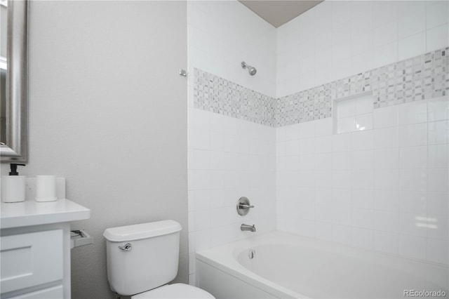 bathroom with tiled shower / bath combo and toilet