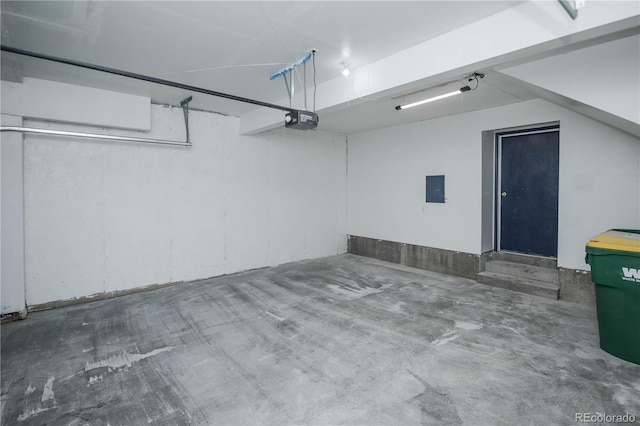 garage with electric panel and a garage door opener