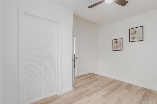 unfurnished bedroom featuring light wood-type flooring, a closet, and ceiling fan