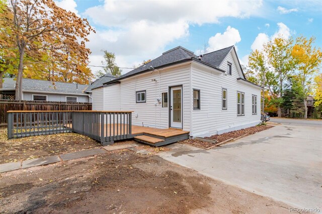 view of front of house featuring a wooden deck and a patio