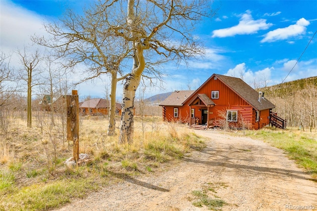 82 Sheep Ridge Rd, Fairplay, CO 80440 - cabin featuring driveway, log exterior, roof with shingles, and board and batten siding