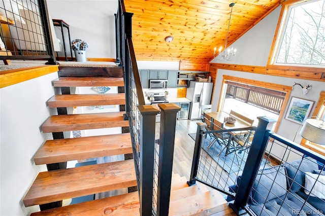 82 Sheep Ridge Rd, Fairplay, CO 80440 - stairway featuring wooden ceiling, wood finished floors, and a chandelier