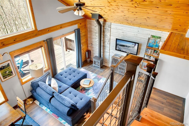 82 Sheep Ridge Rd, Fairplay, CO 80440 - living area with wood walls, a ceiling fan, wood finished floors, and a wood stove