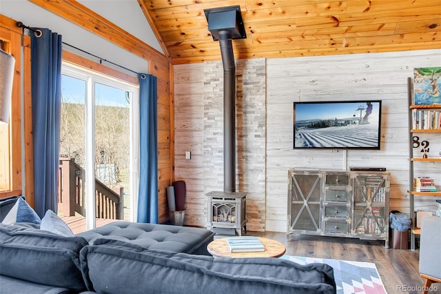 82 Sheep Ridge Rd, Fairplay, CO 80440 - living area featuring a wood stove, vaulted ceiling, wood walls, wood finished floors, and wooden ceiling