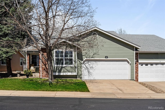 view of front of home with a garage, brick siding, and driveway
