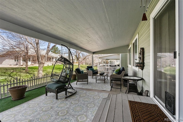 deck with outdoor lounge area, fence, and a patio area