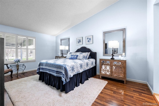 bedroom featuring vaulted ceiling, dark wood-style flooring, baseboards, and a textured ceiling