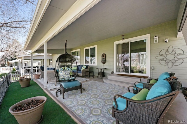 view of patio featuring fence and an outdoor living space