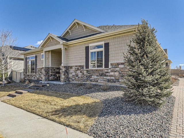 view of front of property featuring stone siding and covered porch