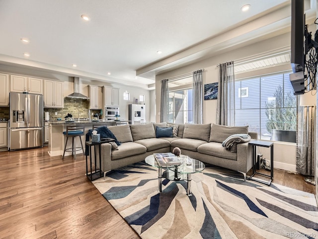 living room with wood finished floors and recessed lighting