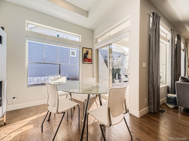 dining room with baseboards and wood finished floors