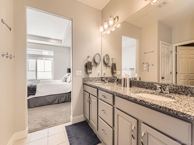 full bath featuring ensuite bath, tile patterned flooring, a sink, and visible vents