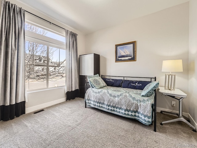 carpeted bedroom featuring visible vents and baseboards