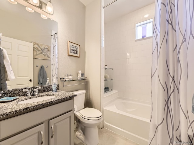 bathroom featuring a textured wall, toilet, shower / bath combo with shower curtain, vanity, and tile patterned flooring