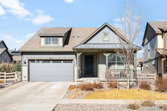 view of front of house with fence, a porch, board and batten siding, and concrete driveway