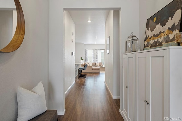 hallway with baseboards and wood finished floors