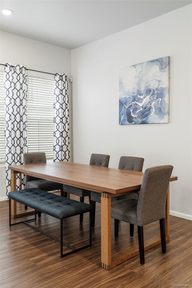 dining area featuring dark wood-style floors and baseboards