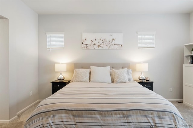 bedroom featuring baseboards and carpet flooring