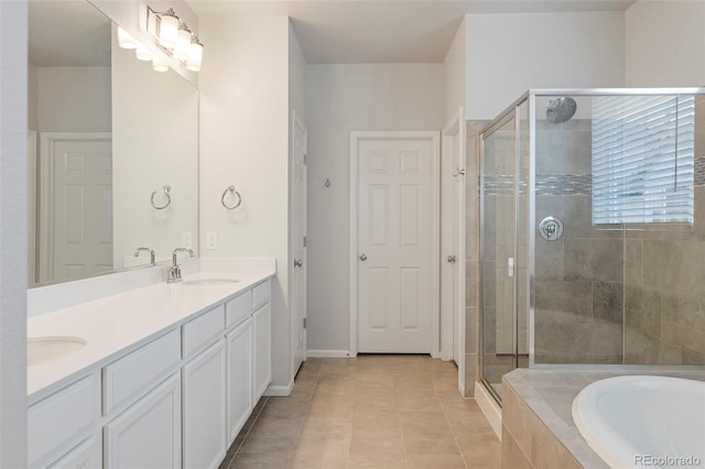 full bathroom with double vanity, tiled bath, a sink, a shower stall, and tile patterned floors