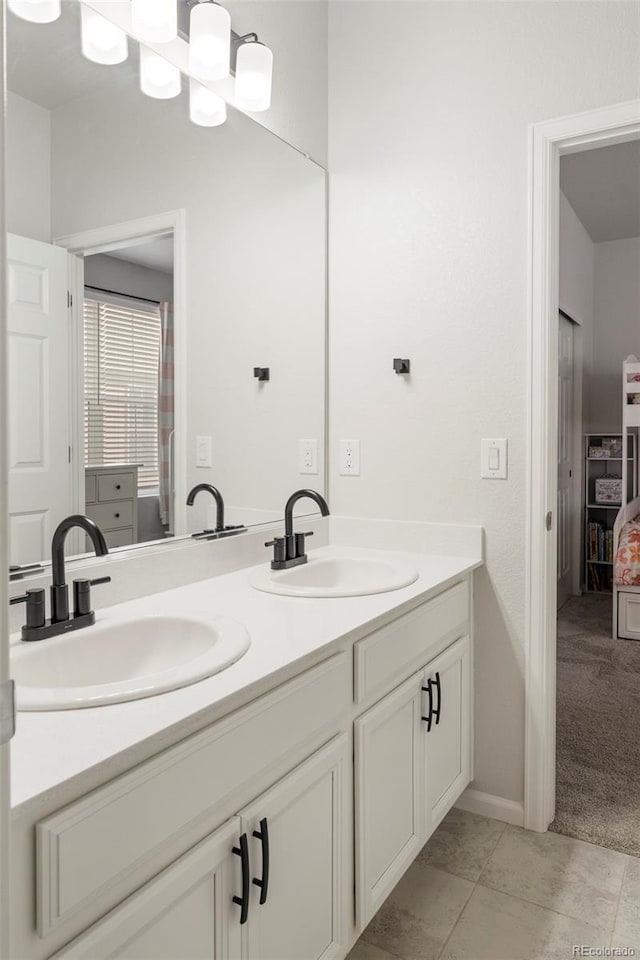 bathroom featuring double vanity, tile patterned flooring, and a sink