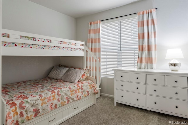 bedroom featuring light colored carpet and multiple windows