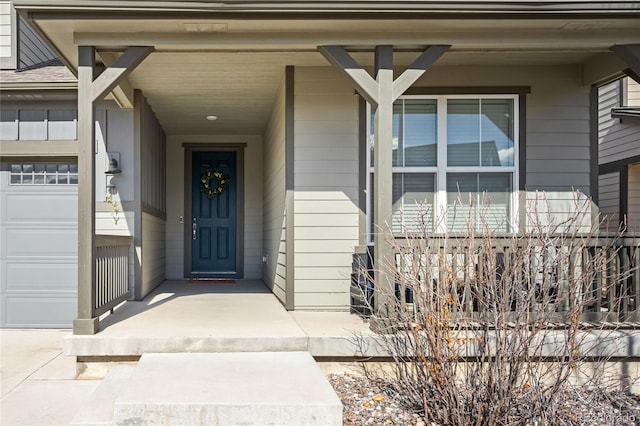 entrance to property featuring a garage and a porch