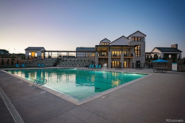 pool with a patio area and fence