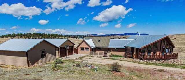 2177 County Road 341, Westcliffe, CO 81252 - view of front of property featuring metal roof, a wooden deck, and driveway