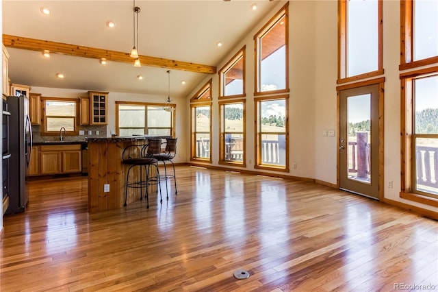 2177 County Road 341, Westcliffe, CO 81252 - kitchen with a sink, a breakfast bar area, wood finished floors, glass insert cabinets, and freestanding refrigerator
